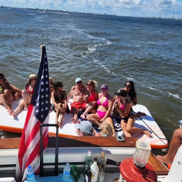 Group under the flag off the stern